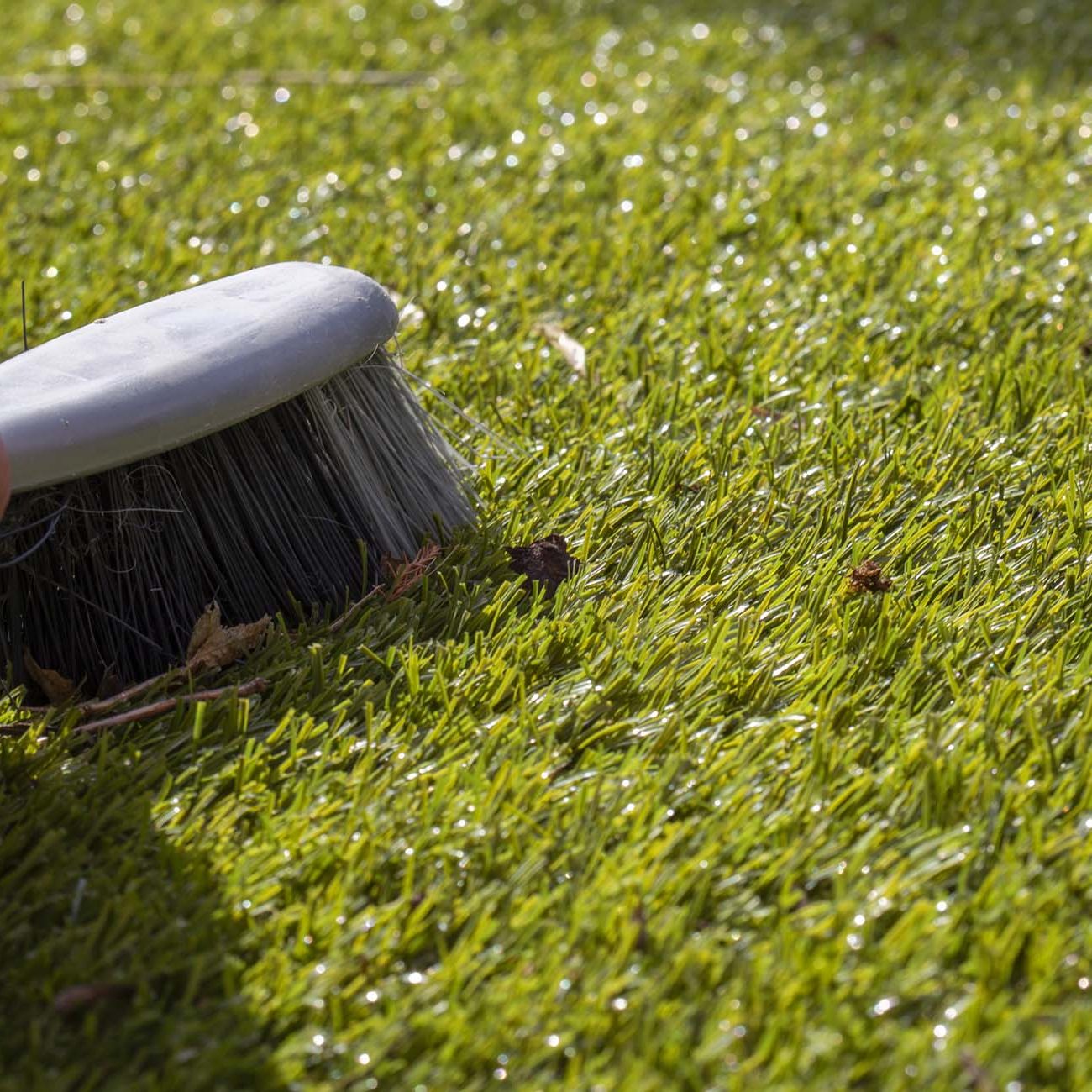 brushing artificial grass